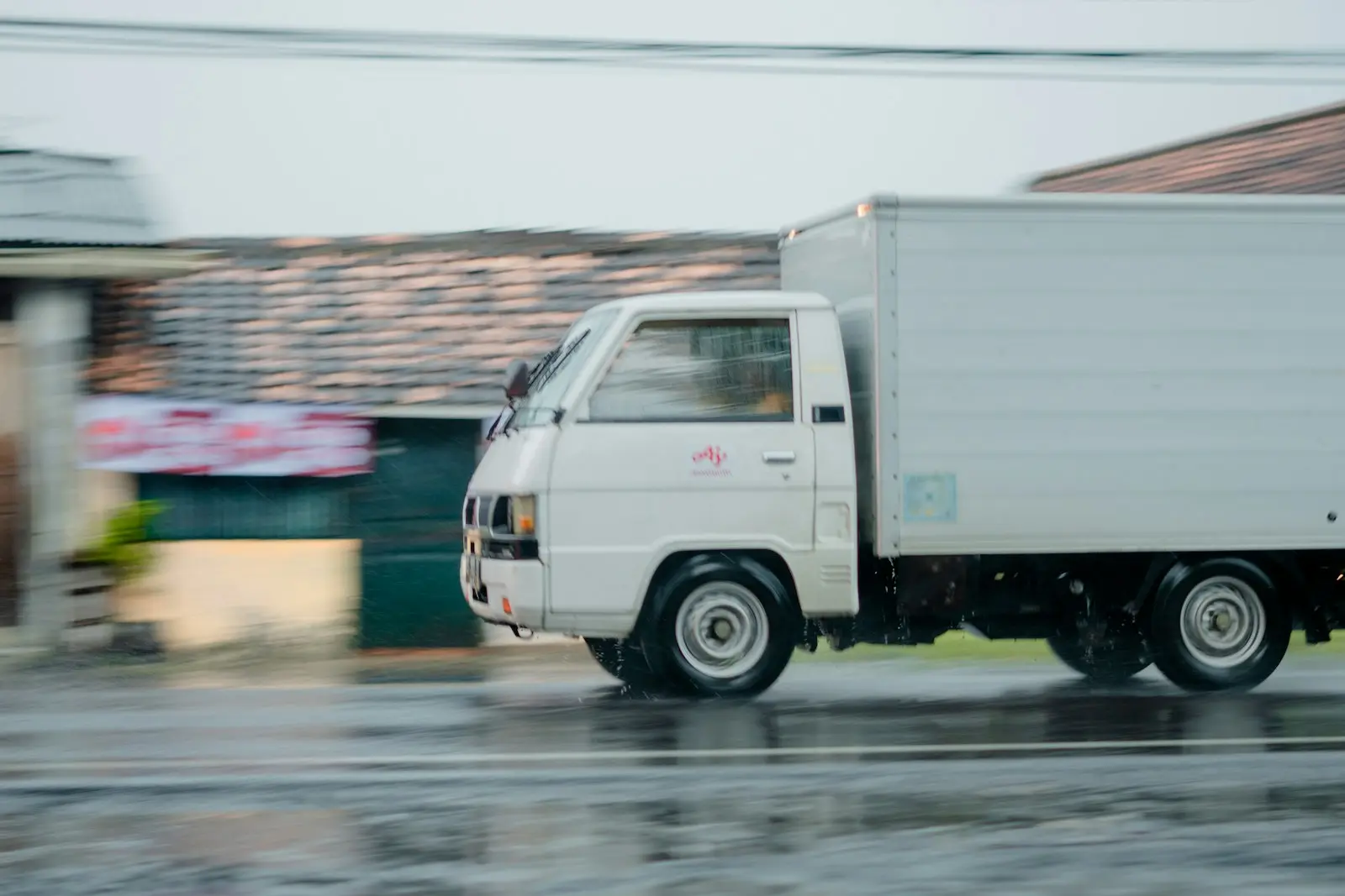 White box truck parked at a loading area
