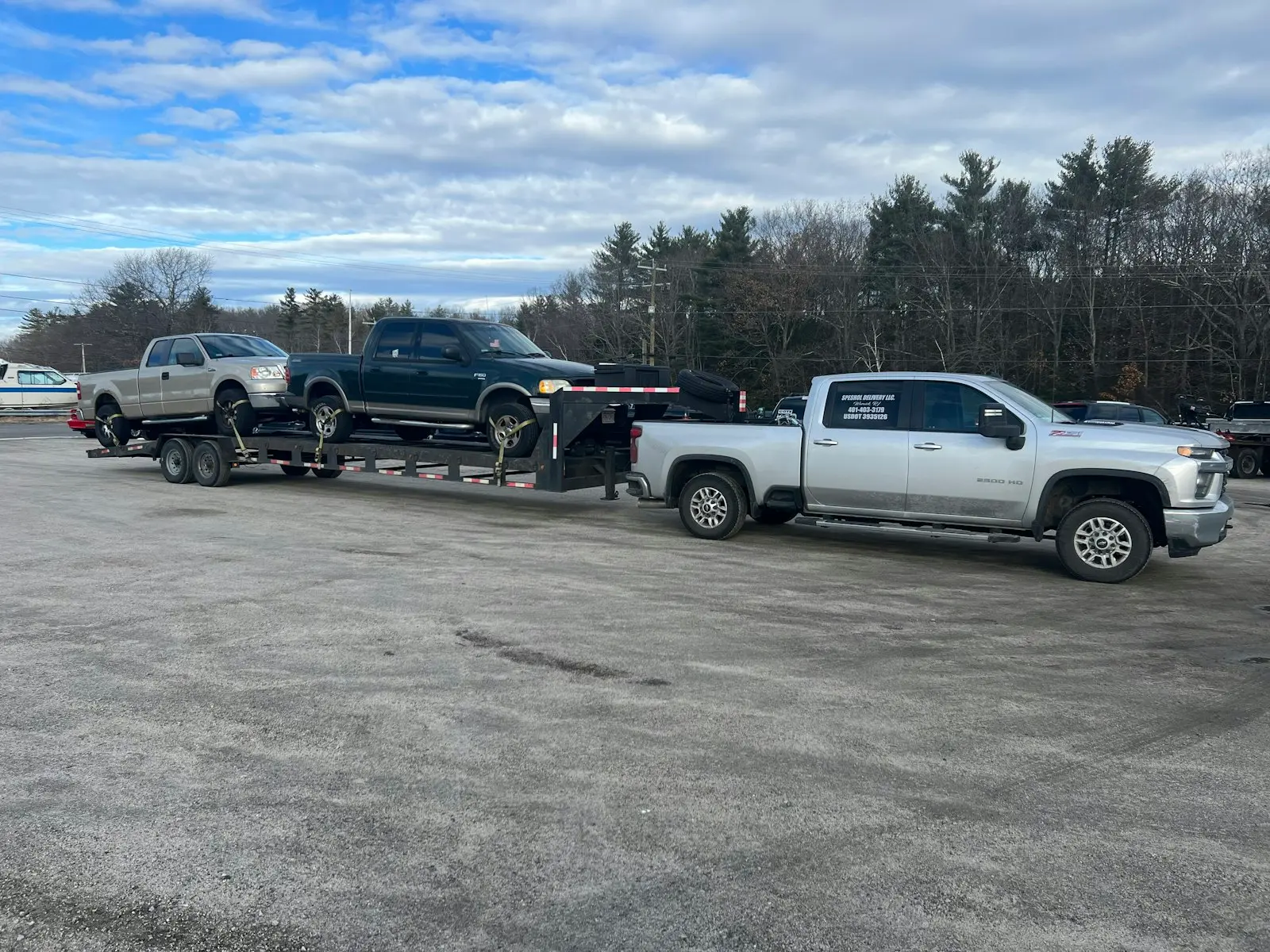 Heavy-duty pickup truck pulling a gooseneck flatbed trailer